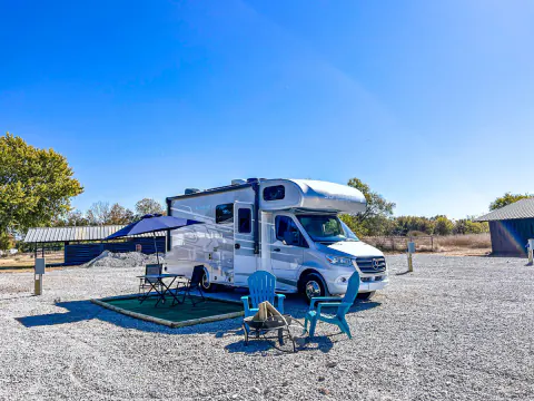 Motorhome on a gravel RV site under a blue sky