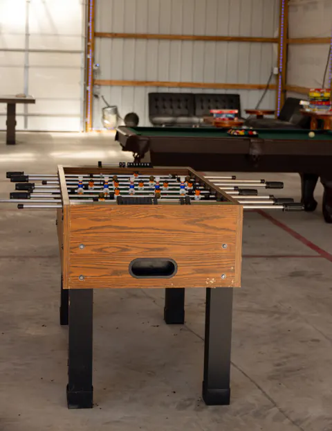 Foosball and billiards tables in the game room