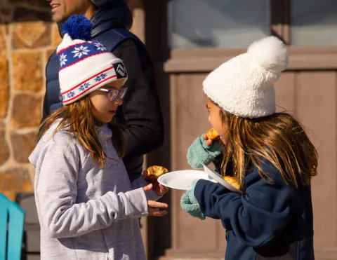 Young guests sharing snacks at a Lake Hudson Resort get-together
