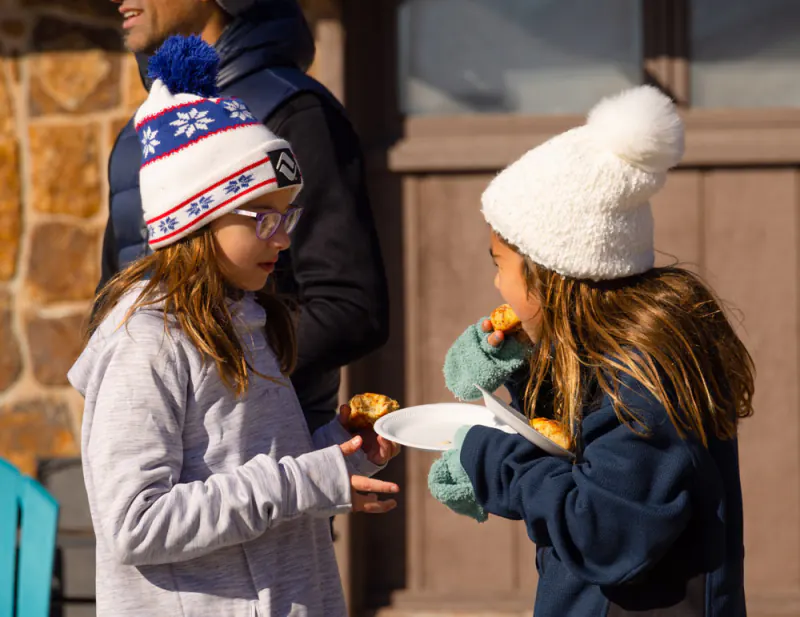 Young guests sharing snacks at a Lake Hudson Resort get-together