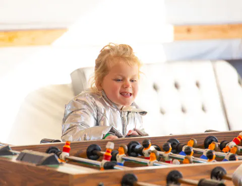 Little girl playing foosball