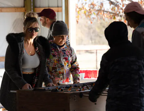 Guests gathered around the foosball table