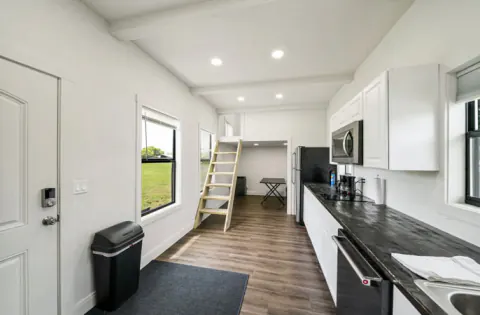 Kitchen with a loft ladder inside the cabin