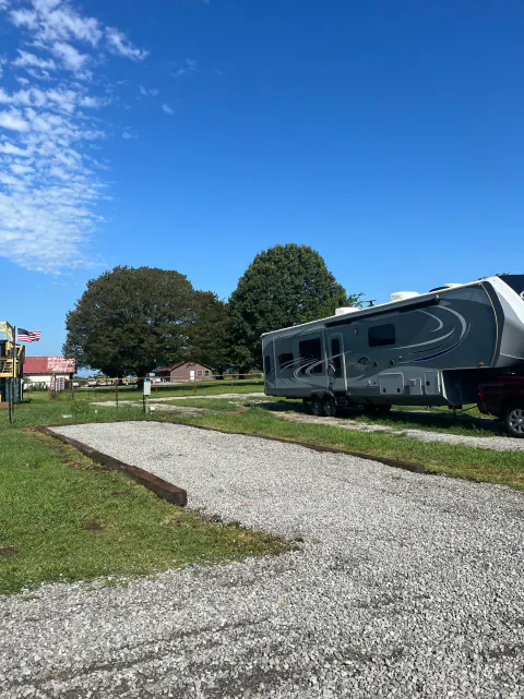 Gravel RV site next to a fifth-wheel trailer