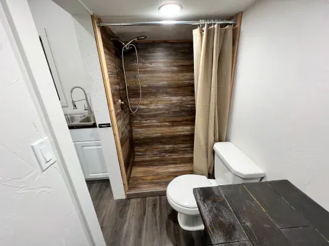 Bathroom with a wood-look shower inside the cabin