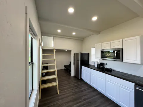 Kitchen and loft ladder inside the cabin